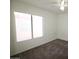 Bedroom with ceiling fan and a large window at 14334 W Avalon Dr, Goodyear, AZ 85395