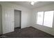 Bright carpeted bedroom with large window and double door closet at 14334 W Avalon Dr, Goodyear, AZ 85395