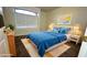 Bright bedroom boasts a cozy blue bed, ample natural light, and modern decor at 14334 W Avalon Dr, Goodyear, AZ 85395