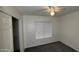 Bedroom featuring neutral walls, carpet, and a ceiling fan with a light fixture at 14334 W Avalon Dr, Goodyear, AZ 85395