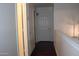 Hallway with a white door and dark floors; a simple and clean design at 14334 W Avalon Dr, Goodyear, AZ 85395