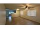 Spacious living room boasting tile flooring, a ceiling fan, and ample natural light at 14334 W Avalon Dr, Goodyear, AZ 85395