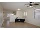 Spacious living room boasts neutral tile floors and an open floor plan at 14334 W Avalon Dr, Goodyear, AZ 85395