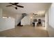Open living room with staircase, tile floors, and sight lines to the kitchen at 14334 W Avalon Dr, Goodyear, AZ 85395