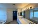 Bathroom showcasing double sink vanity, a soaking tub, and a glass block window at 14334 W Avalon Dr, Goodyear, AZ 85395