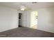 Main bedroom with ceiling fan, neutral carpet, and an ensuite bathroom and walk-in closet at 14334 W Avalon Dr, Goodyear, AZ 85395