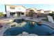 Backyard oasis featuring a private pool, lush landscaping, and covered patio at 14334 W Avalon Dr, Goodyear, AZ 85395