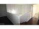 Staircase featuring hardwood flooring with a small pendant light at 14334 W Avalon Dr, Goodyear, AZ 85395