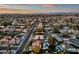 Expansive aerial view of a residential area showcasing neatly lined streets, mature trees, and various swimming pools at 15011 N 45Th Pl, Phoenix, AZ 85032