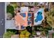 Overhead view of a home with a red tile roof, solar panels, and a backyard with a uniquely shaped pool at 15011 N 45Th Pl, Phoenix, AZ 85032