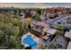 Aerial shot of a home with pool and large trees at sunset, with the pool, covered patio, and barbeque area at 15011 N 45Th Pl, Phoenix, AZ 85032