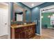 Bathroom with double sink vanity, ample counter space, and blue accent wall at 15011 N 45Th Pl, Phoenix, AZ 85032