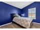 Blue bedroom with a queen bed, shuttered window, and modern design at 15011 N 45Th Pl, Phoenix, AZ 85032