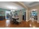 Spacious dining room featuring an elegant chandelier, attractive wall decor, and access to the kitchen at 15011 N 45Th Pl, Phoenix, AZ 85032