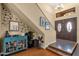 Welcoming foyer with tile flooring, a decorative accent wall, and a staircase leading to the upper level at 15011 N 45Th Pl, Phoenix, AZ 85032