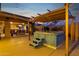 A backyard view showcases a covered hot tub, outdoor kitchen, and patio seating area at 15011 N 45Th Pl, Phoenix, AZ 85032