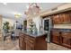 Bright kitchen featuring a granite island, stainless steel refrigerator, and dark wood cabinetry at 15011 N 45Th Pl, Phoenix, AZ 85032