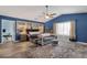 Spacious main bedroom with blue accent wall, built-in shelving and light wood flooring at 15011 N 45Th Pl, Phoenix, AZ 85032