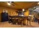 This outdoor kitchen features a built-in grill, a countertop with chairs, and ceiling fans at 15011 N 45Th Pl, Phoenix, AZ 85032