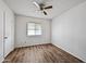 Bedroom with neutral walls, ceiling fan with light, window, and wood-look flooring at 15652 N 52Nd St, Scottsdale, AZ 85254