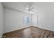 Bedroom with neutral walls, ceiling fan with light, window, and wood-look flooring at 15652 N 52Nd St, Scottsdale, AZ 85254