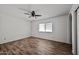 Bedroom with neutral walls, ceiling fan with light, window, and wood-look flooring at 15652 N 52Nd St, Scottsdale, AZ 85254