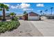 Inviting single-story home featuring desert landscaping with beautiful palm trees at 15652 N 52Nd St, Scottsdale, AZ 85254