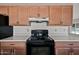 Close-up view of the kitchen features, including the black range and wood cabinets at 15652 N 52Nd St, Scottsdale, AZ 85254