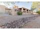 Backyard with gravel, rock drainage and partial view of covered patio at 15843 E Mustang Dr, Fountain Hills, AZ 85268