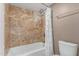 The bathroom features an aged-stone shower with a white tub and toilet at 15843 E Mustang Dr, Fountain Hills, AZ 85268