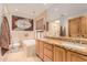 Spa-like bathroom with double sinks, a soaking tub, and a large mirror for a luxurious experience at 15843 E Mustang Dr, Fountain Hills, AZ 85268