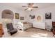 Bright bedroom with colorful decor, a white bed, a window with blinds, and comfortable seating at 15843 E Mustang Dr, Fountain Hills, AZ 85268