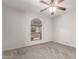 Cozy bedroom featuring a ceiling fan and view of the green landscape through the window at 15843 E Mustang Dr, Fountain Hills, AZ 85268