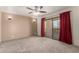Comfortable bedroom featuring a ceiling fan, carpet, and sliding door access at 15843 E Mustang Dr, Fountain Hills, AZ 85268