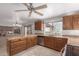 Open kitchen with adjacent dining area, featuring wooden cabinets and stainless steel appliances at 15843 E Mustang Dr, Fountain Hills, AZ 85268