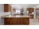 Well-lit kitchen featuring custom wood cabinets, granite countertops, stainless steel appliances, and tile floors at 15843 E Mustang Dr, Fountain Hills, AZ 85268