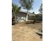 View of the spacious backyard featuring trees and potential for landscaping at 1630 N 58Th Ave, Phoenix, AZ 85035