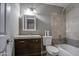 Bathroom featuring a modern vanity, neutral walls, and a shower-tub combination with stylish tile at 1630 N 58Th Ave, Phoenix, AZ 85035