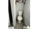 A small bathroom featuring a toilet, tile flooring, and a shelf for storage at 1630 N 58Th Ave, Phoenix, AZ 85035