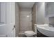 This bathroom features tile surround and flooring and a modern vanity at 1630 N 58Th Ave, Phoenix, AZ 85035