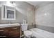 Bathroom featuring a modern vanity, neutral walls, and a shower-tub combination with stylish tile at 1630 N 58Th Ave, Phoenix, AZ 85035