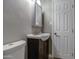 This bathroom features a dark vanity and a decorative mirror and lighting at 1630 N 58Th Ave, Phoenix, AZ 85035