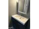 Bathroom vanity features a white countertop, dark wood cabinet, and modern faucet at 1630 N 58Th Ave, Phoenix, AZ 85035