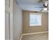 Bright bedroom with wood-look tile flooring, neutral walls, and ample natural light from the window at 1630 N 58Th Ave, Phoenix, AZ 85035