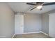 Bedroom showcasing wood-look flooring, a ceiling fan, and a closet with a full-length door at 1630 N 58Th Ave, Phoenix, AZ 85035