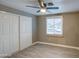 Cozy bedroom with wood-look floors, a ceiling fan, and a closet with sliding doors for ample storage at 1630 N 58Th Ave, Phoenix, AZ 85035