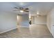 Spacious living room with ceiling fans and modern flooring flowing into the open kitchen at 1630 N 58Th Ave, Phoenix, AZ 85035