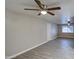 Spacious living room with modern wood-look flooring, neutral paint, and a ceiling fan at 1630 N 58Th Ave, Phoenix, AZ 85035