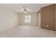 Carpeted bedroom with ceiling fan and bright window at 17247 N 106Th Ave, Sun City, AZ 85373