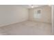 Neutral carpeted bedroom with ceiling fan and bright window at 17247 N 106Th Ave, Sun City, AZ 85373